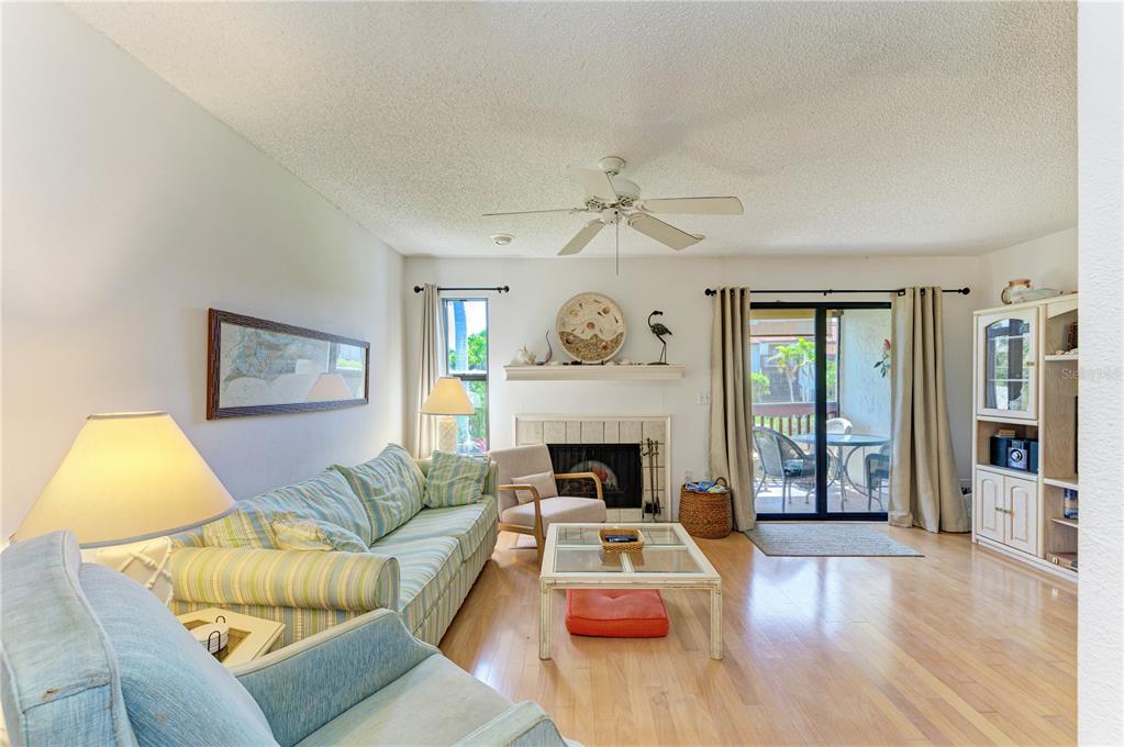 6840 Midnight Pass Road, Unit 6840 Sarasota, FL 34242 - Photo 15 of 66 a living room with furniture and a fireplace