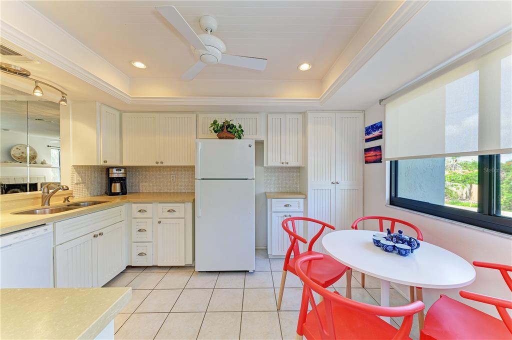 6840 Midnight Pass Road, Unit 6840 Sarasota, FL 34242 - Photo 18 of 66 a kitchen with stainless steel appliances granite countertop a refrigerator and a stove top oven