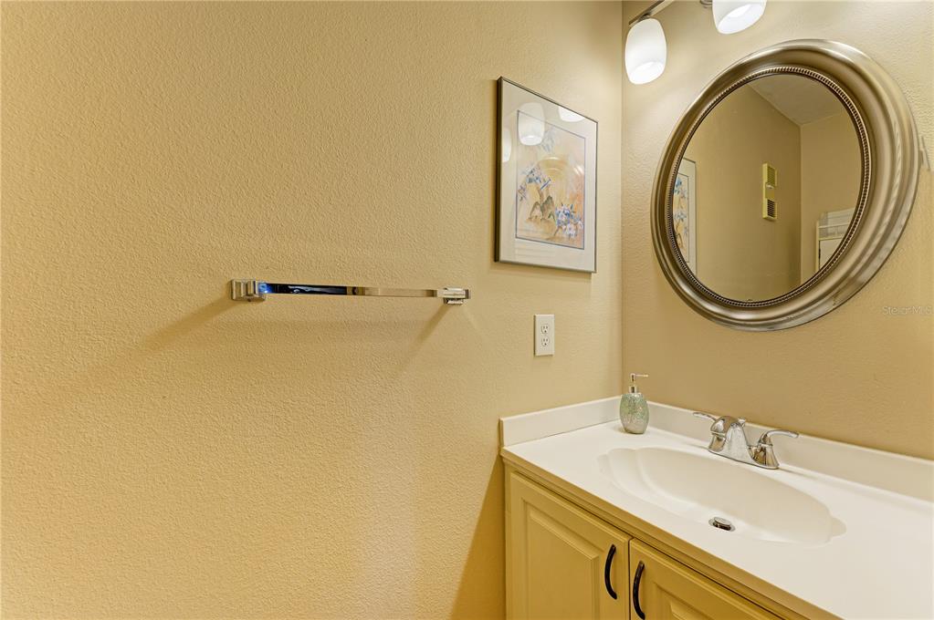 6840 Midnight Pass Road, Unit 6840 Sarasota, FL 34242 - Photo 23 of 66 a bathroom with a sink and a mirror
