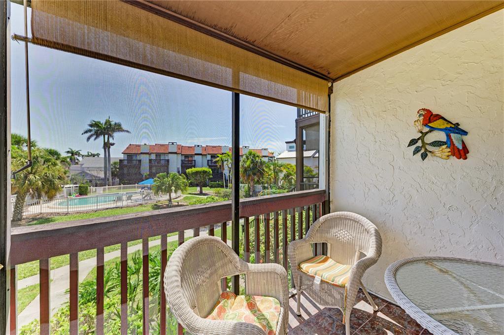 6840 Midnight Pass Road, Unit 6840 Sarasota, FL 34242 - Photo 26 of 66 a view of a balcony dining table and chairs