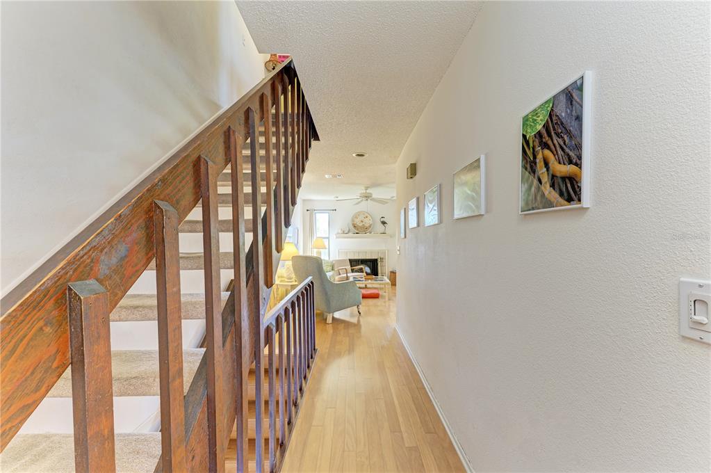 6840 Midnight Pass Road, Unit 6840 Sarasota, FL 34242 - Photo 31 of 66 a view of a hallway with wooden floor and staircase
