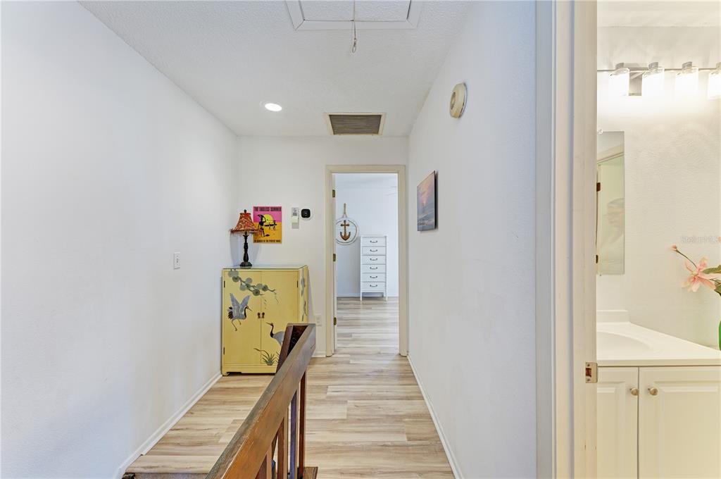 6840 Midnight Pass Road, Unit 6840 Sarasota, FL 34242 - Photo 32 of 66 a view of a hallway with wooden floor and staircase
