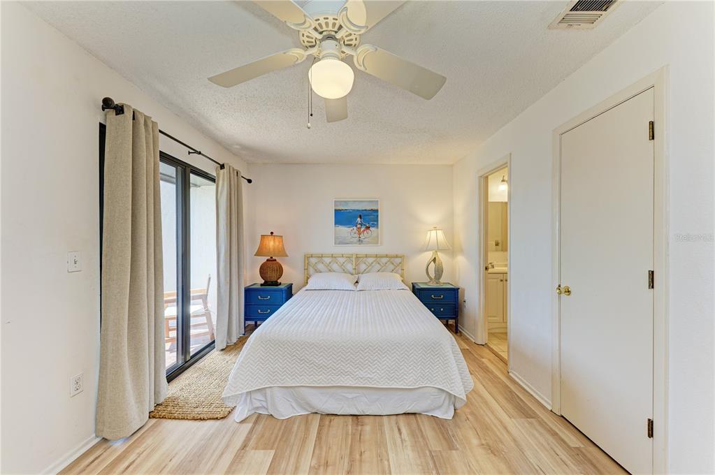 6840 Midnight Pass Road, Unit 6840 Sarasota, FL 34242 - Photo 34 of 66 a view of a hallway with wooden floor and chandelier
