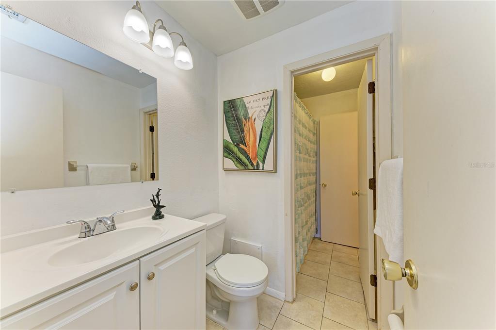 6840 Midnight Pass Road, Unit 6840 Sarasota, FL 34242 - Photo 39 of 66 a bathroom with a toilet sink and mirror