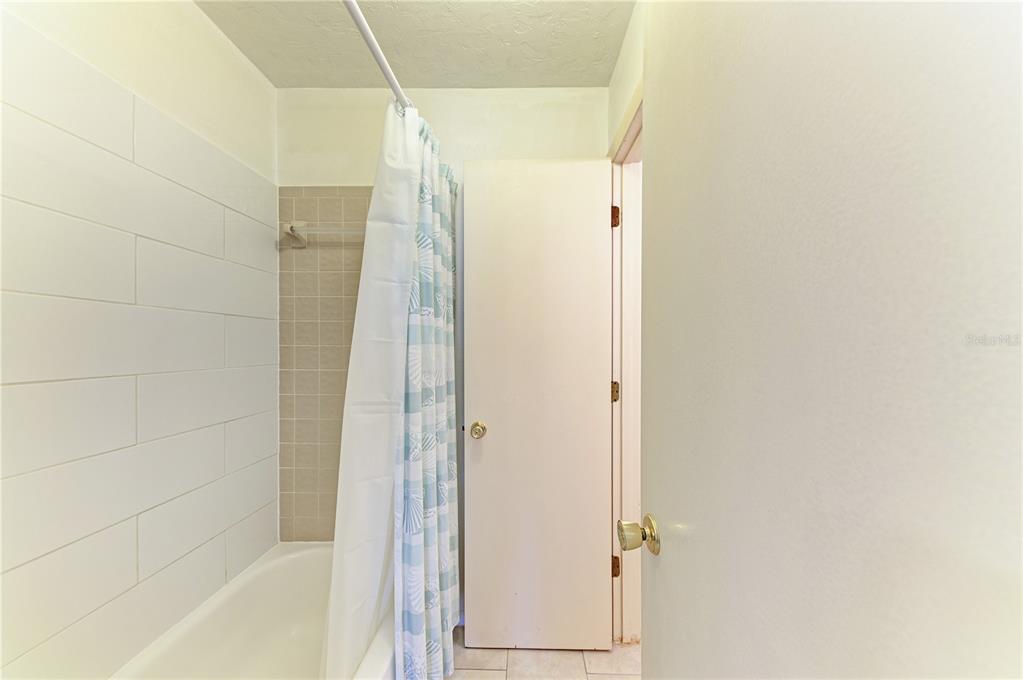 6840 Midnight Pass Road, Unit 6840 Sarasota, FL 34242 - Photo 40 of 66 a bathroom with a glass shower door