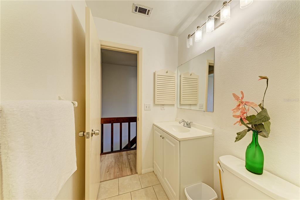 6840 Midnight Pass Road, Unit 6840 Sarasota, FL 34242 - Photo 41 of 66 a bathroom with a sink a toilet and mirror