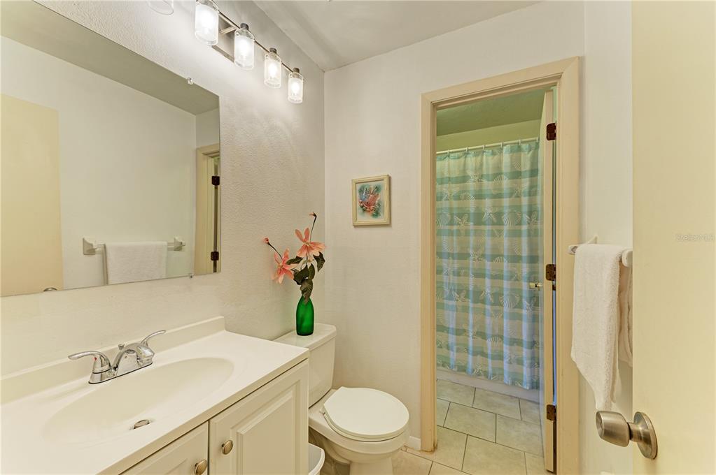 6840 Midnight Pass Road, Unit 6840 Sarasota, FL 34242 - Photo 42 of 66 a bathroom with a sink a toilet and shower