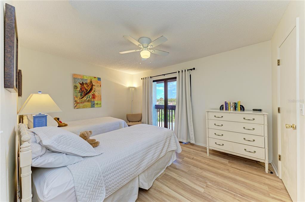 6840 Midnight Pass Road, Unit 6840 Sarasota, FL 34242 - Photo 48 of 66 a bedroom with a bed and a dresser