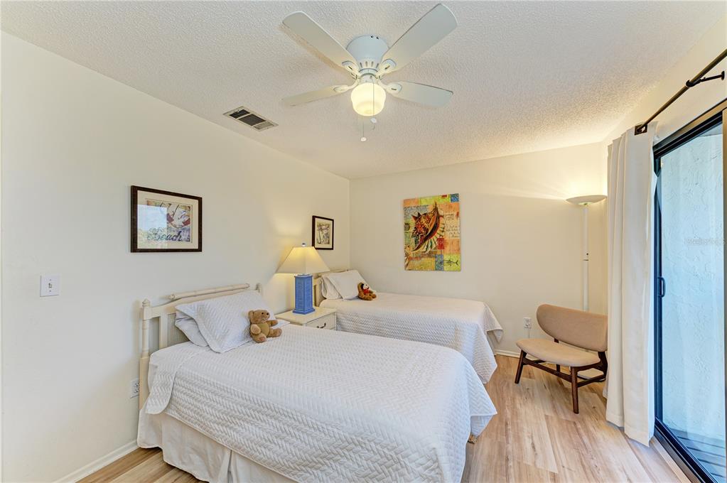 6840 Midnight Pass Road, Unit 6840 Sarasota, FL 34242 - Photo 49 of 66 a bedroom with a bed and a table