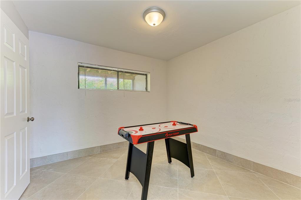 6840 Midnight Pass Road, Unit 6840 Sarasota, FL 34242 - Photo 56 of 66 a room with a table and a window