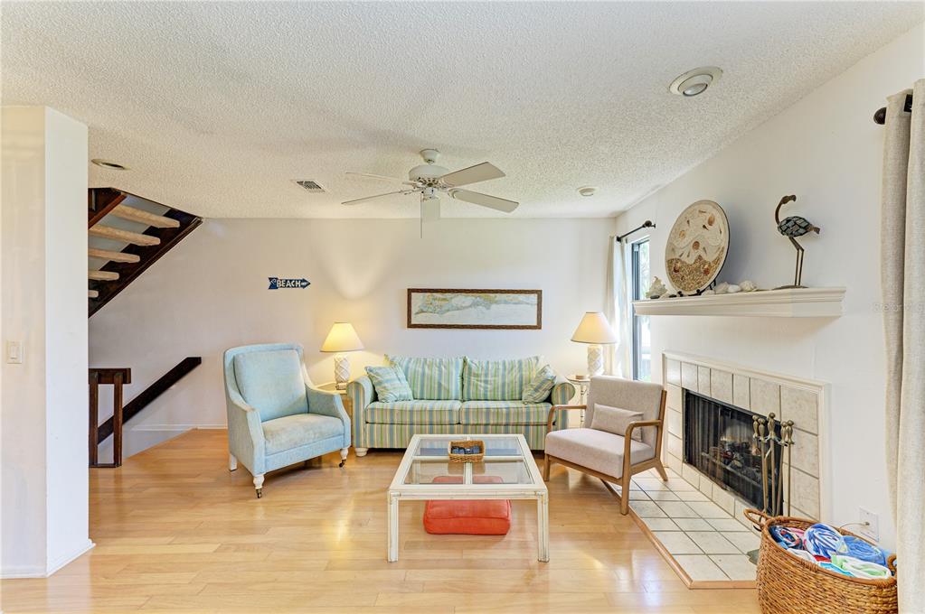 6840 Midnight Pass Road, Unit 6840 Sarasota, FL 34242 - Photo 9 of 66 a living room with furniture and a fireplace