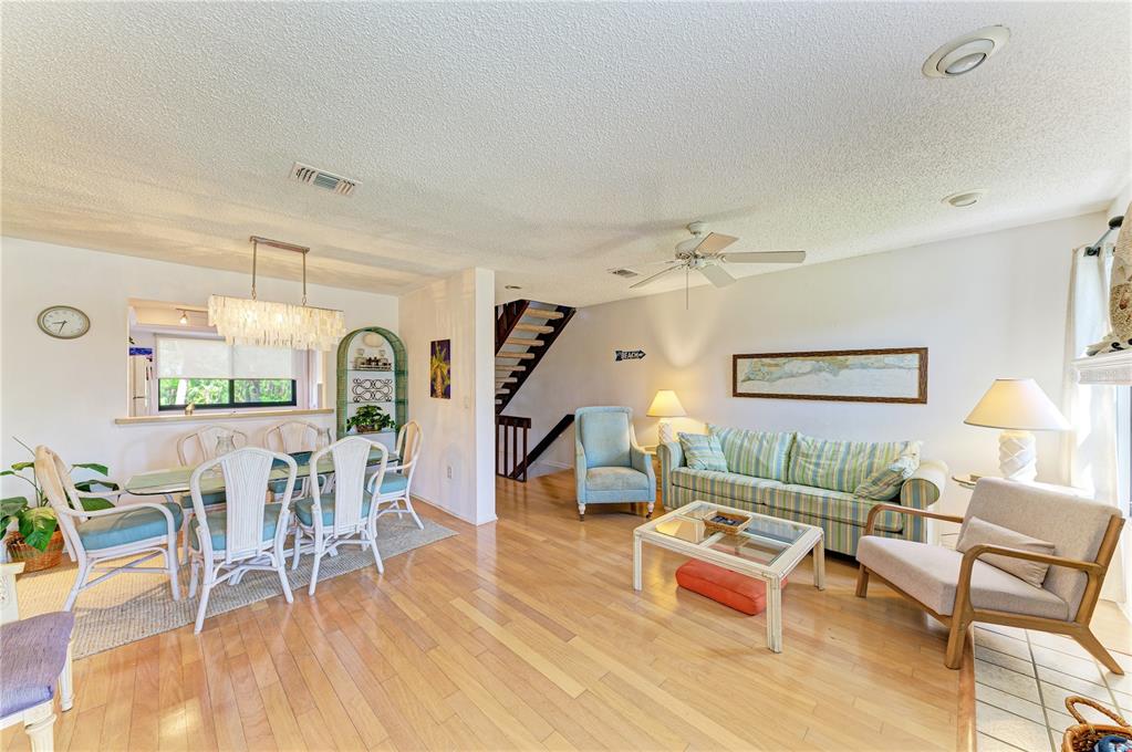 6840 Midnight Pass Road, Unit 6840 Sarasota, FL 34242 - Photo 10 of 66 a living room with furniture and a wooden floor