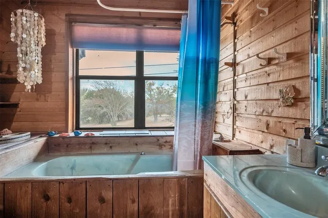 a bathroom with a granite countertop sink and a large mirror
