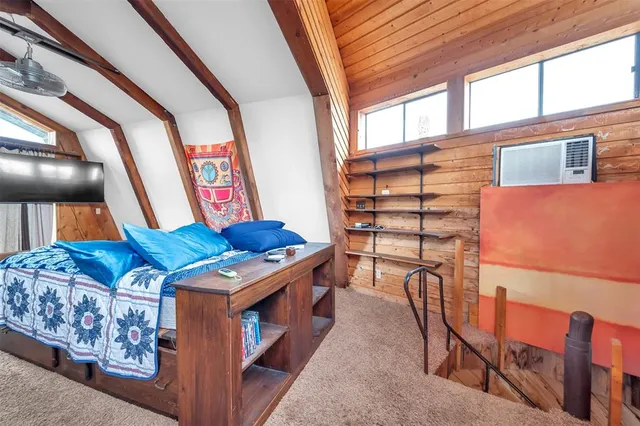 a bedroom with furniture and a window