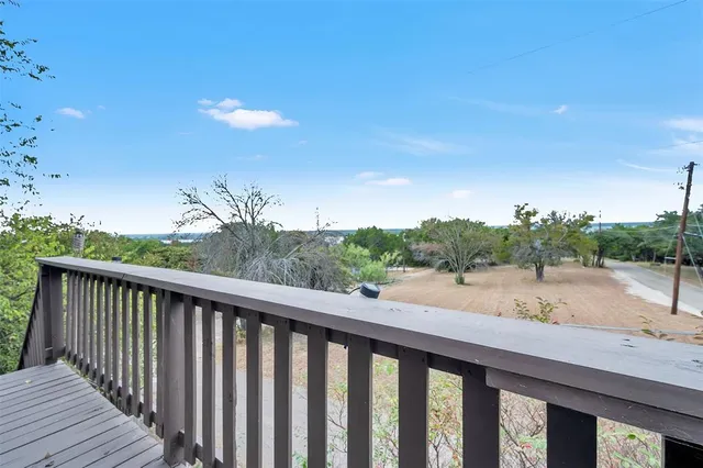 a balcony with wooden floor and outdoor space
