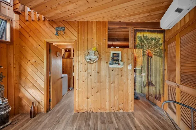 a view of a porch with wooden floor and furniture