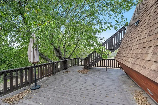 a view of balcony with wooden floor and fence