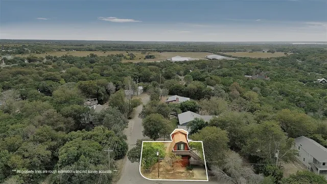 an aerial view of a houses with a yard