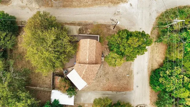 an aerial view of a house with a yard