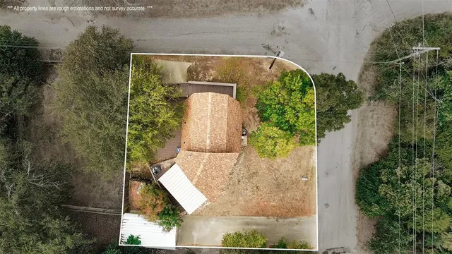 an aerial view of residential houses with outdoor space and lake view