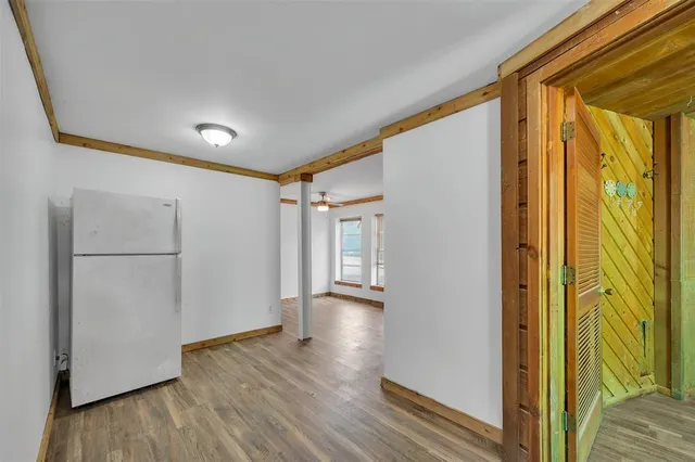a view of hallway with wooden floor