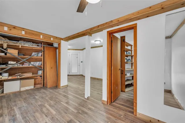 a view of empty room with wooden floor