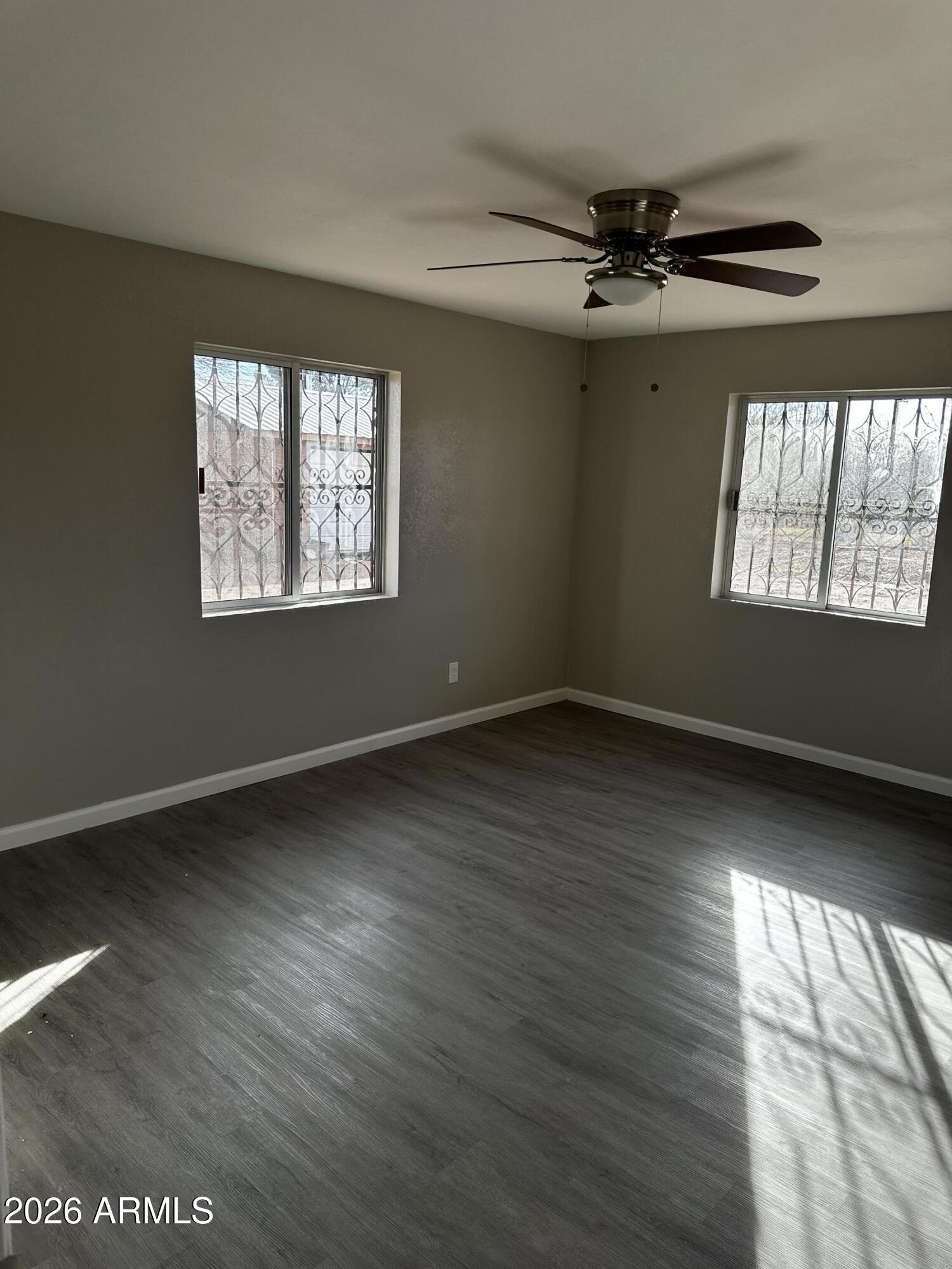217 East 21st Street Douglas, AZ 85607 - Photo 12 of 22 wooden floor in an empty room with a window