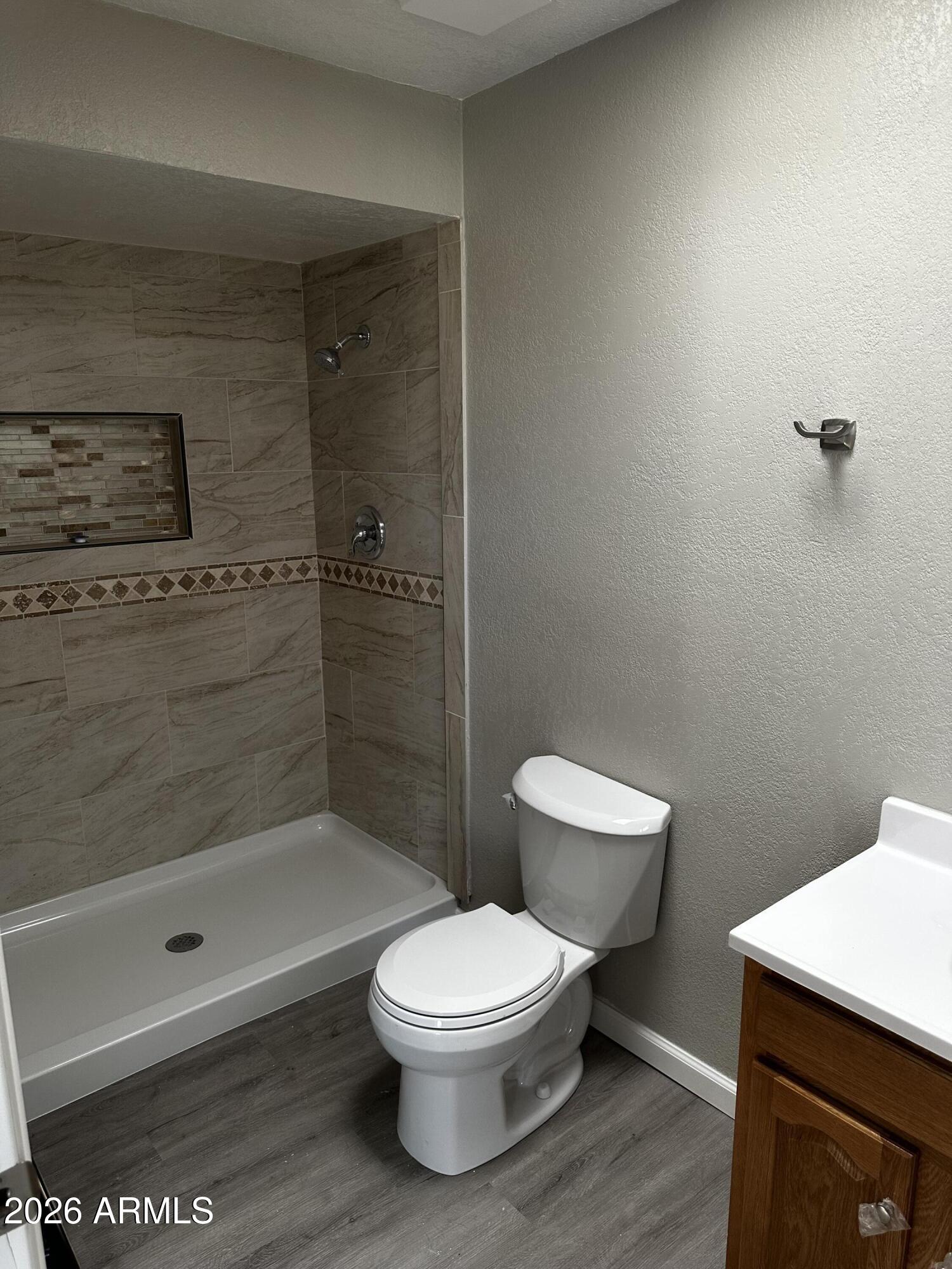 217 East 21st Street Douglas, AZ 85607 - Photo 18 of 23 a bathroom with a toilet a sink and shower