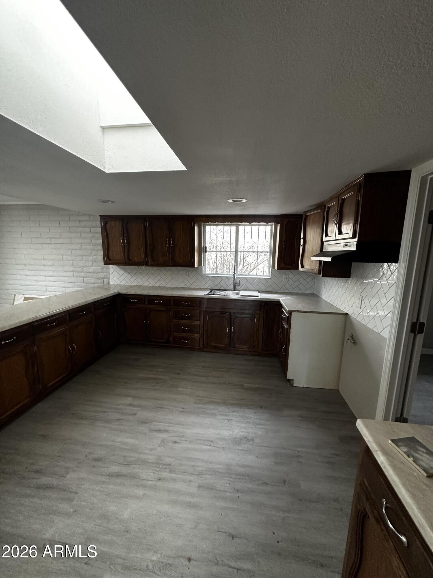 217 East 21st Street Douglas, AZ 85607 - Photo 5 of 22 a large kitchen with stainless steel appliances granite countertop a sink and a stove