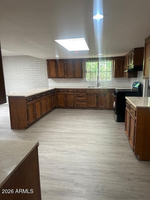 217 East 21st Street Douglas, AZ 85607 - Photo 5 of 23 a kitchen with stainless steel appliances kitchen island granite countertop a stove a sink and a microwave
