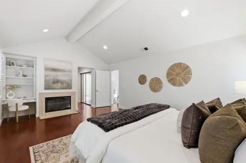 a bedroom with a bed and a fireplace