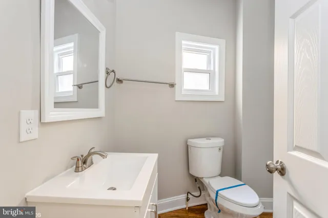 a white toilet sitting next to a bathroom sink