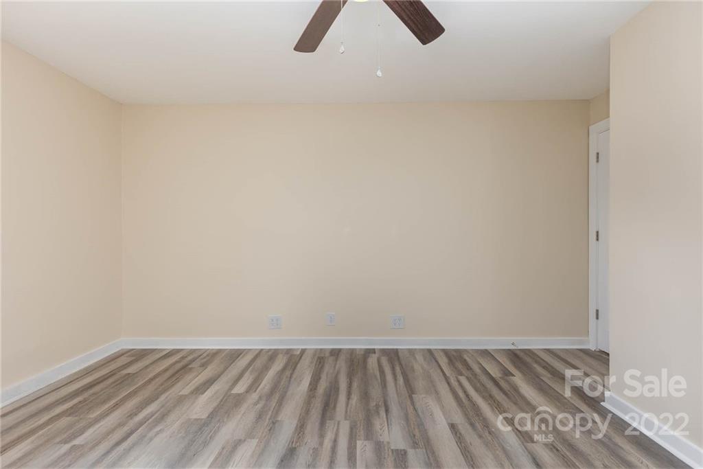 304 West Poplar Street Stanley, NC 28164 - Photo 13 of 21 a view of an empty room with wooden floor