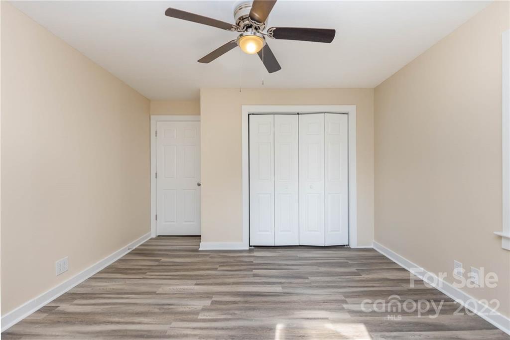304 West Poplar Street Stanley, NC 28164 - Photo 14 of 21 a view of empty room with wooden floor
