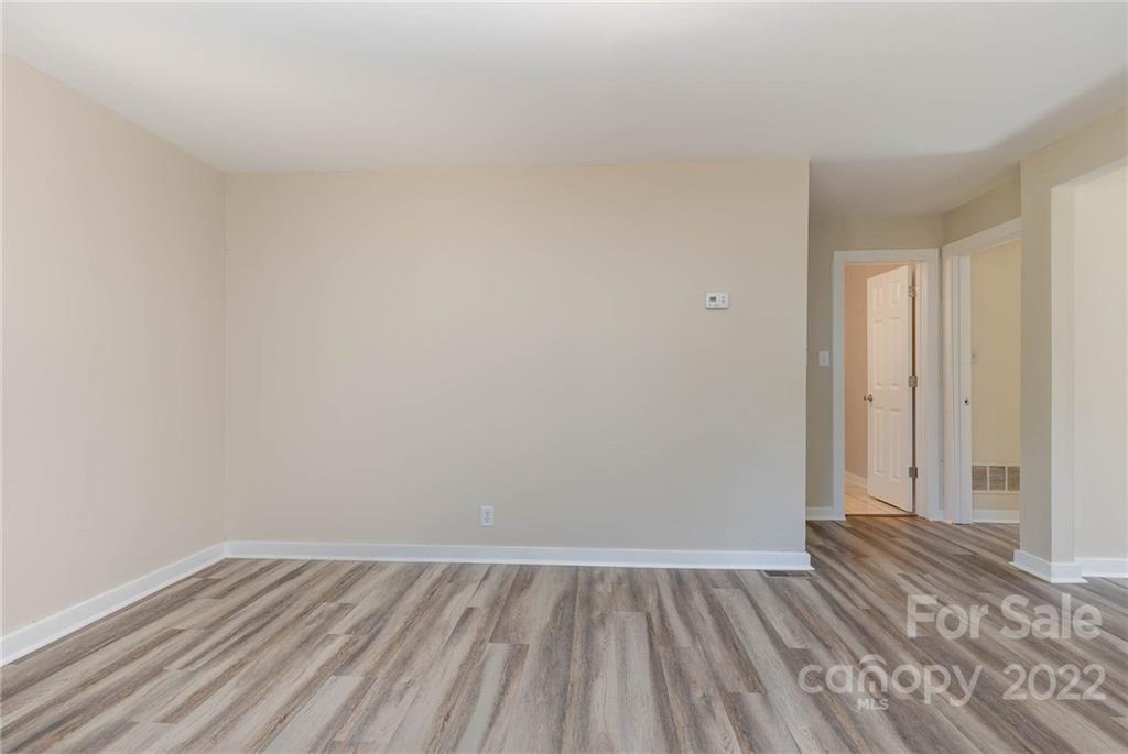 304 West Poplar Street Stanley, NC 28164 - Photo 15 of 21 a view of an empty room and wooden floor