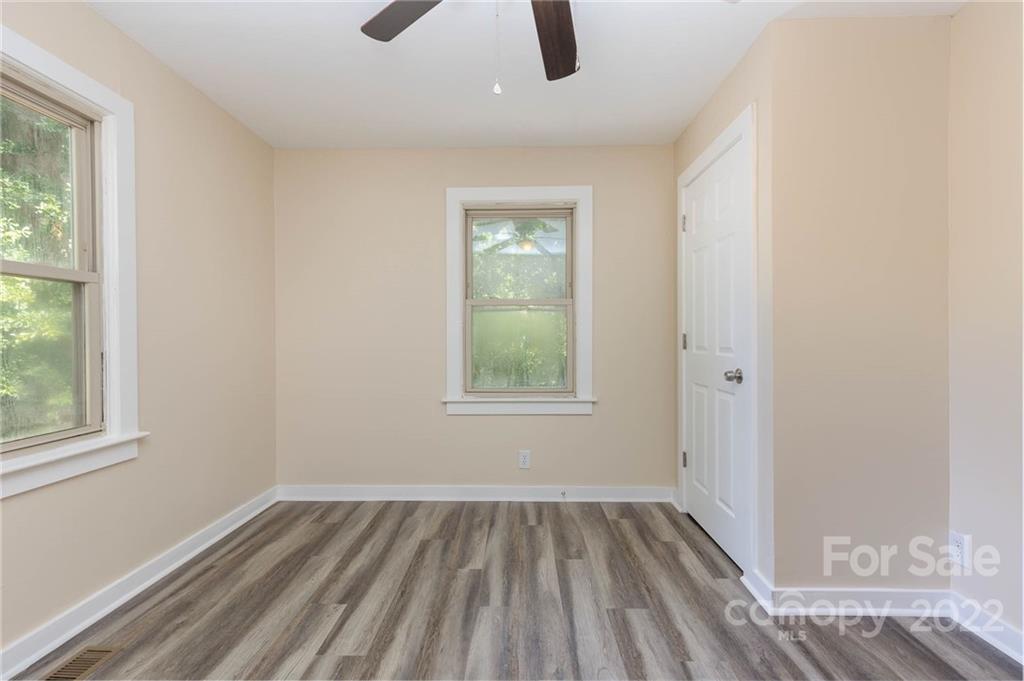 304 West Poplar Street Stanley, NC 28164 - Photo 16 of 21 a view of an empty room with wooden floor and window