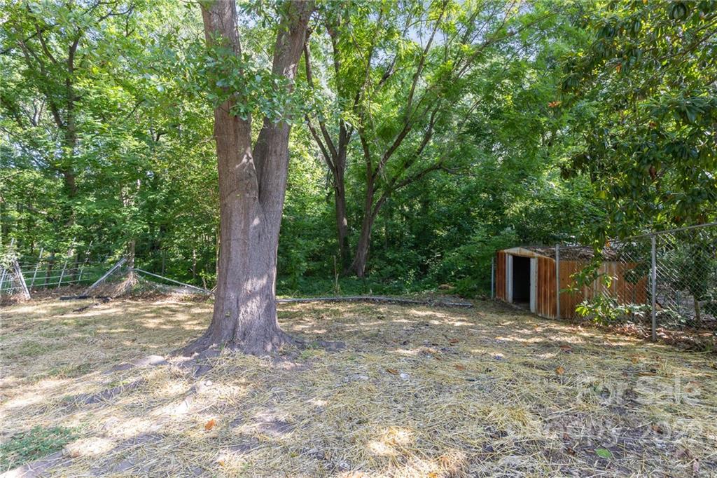 304 West Poplar Street Stanley, NC 28164 - Photo 20 of 21 a view of a backyard with trees