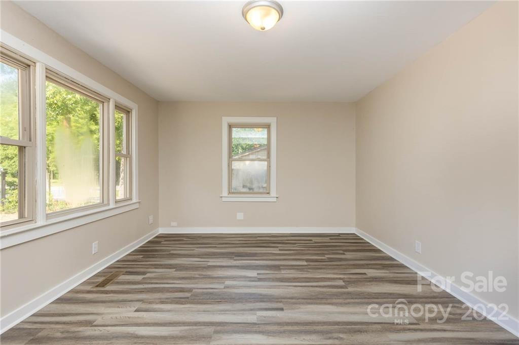 304 West Poplar Street Stanley, NC 28164 - Photo 3 of 21 a view of a livingroom with wooden floor and window