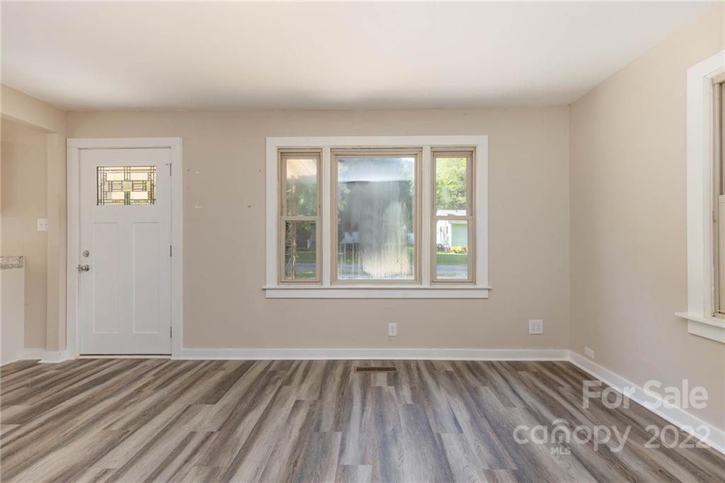 304 West Poplar Street Stanley, NC 28164 - Photo 4 of 21 a view of an empty room with wooden floor and a window