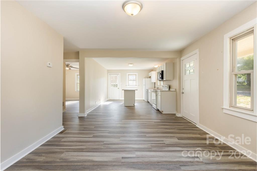 304 West Poplar Street Stanley, NC 28164 - Photo 5 of 21 a view of a kitchen with wooden floor and windows