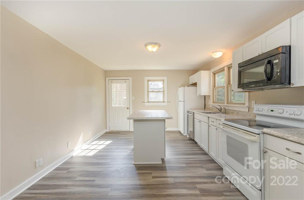304 West Poplar Street Stanley, NC 28164 - Photo 6 of 21 a kitchen with a sink cabinets and wooden floor