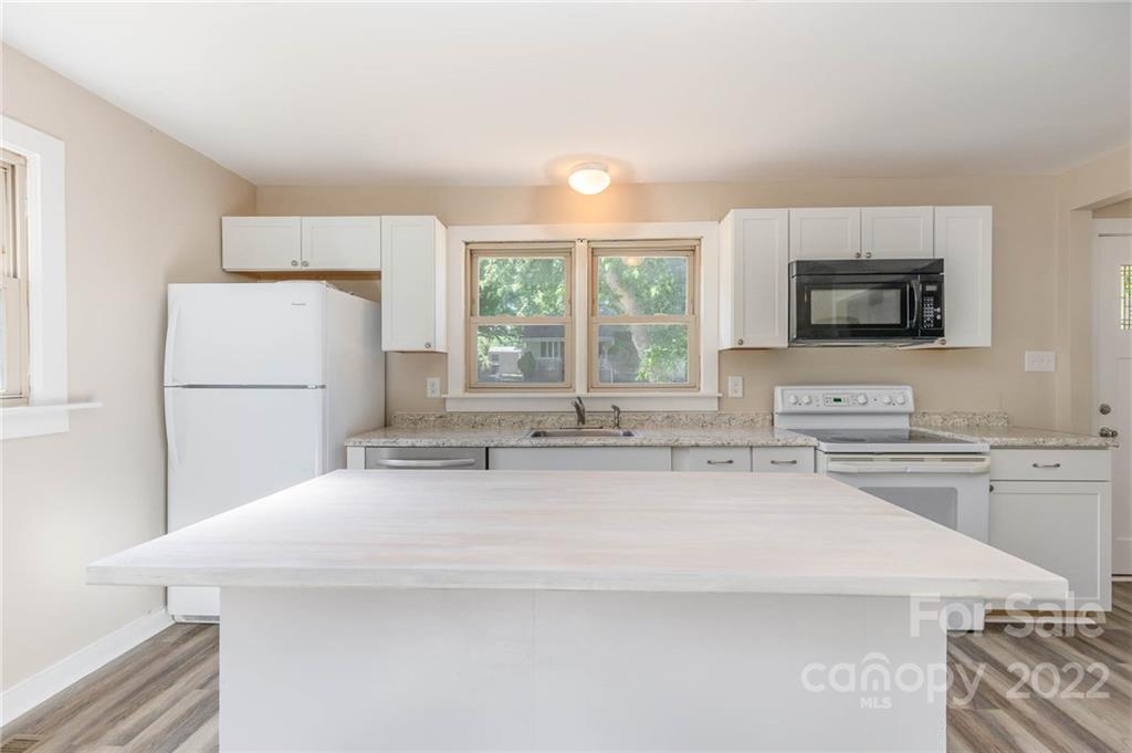 304 West Poplar Street Stanley, NC 28164 - Photo 7 of 21 a kitchen with stainless steel appliances granite countertop a sink stove and refrigerator