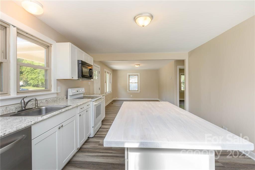 304 West Poplar Street Stanley, NC 28164 - Photo 8 of 21 a large white kitchen with sink and window