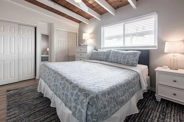 a bedroom with a bed and a window