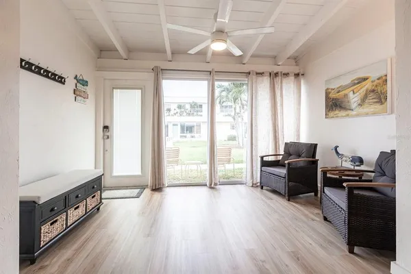 a view of a livingroom with furniture window and wooden floor