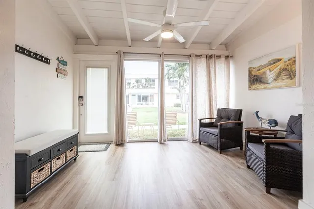a view of a livingroom with furniture window and wooden floor