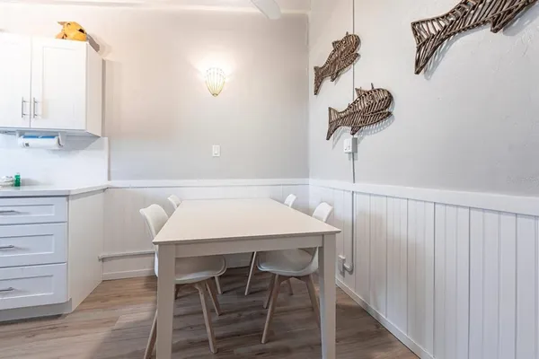 a dining table with chairs and wooden floor