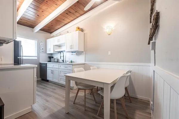 a kitchen with a table chairs sink and cabinets