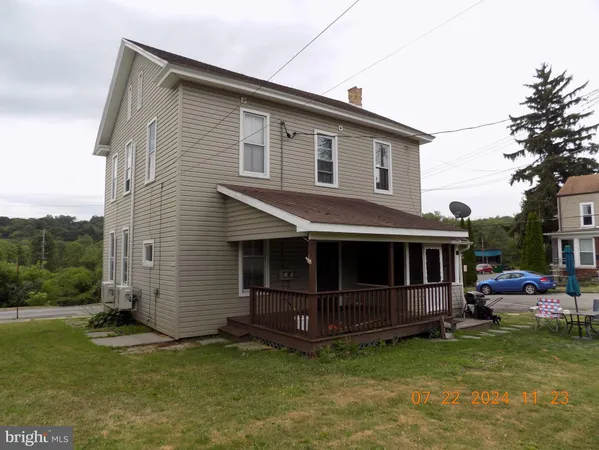 a view of a house with a balcony and yard