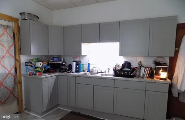 a kitchen with a sink a window and cabinets
